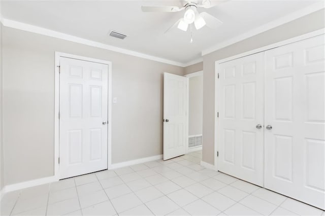 unfurnished bedroom featuring a closet, ceiling fan, crown molding, and light tile patterned floors