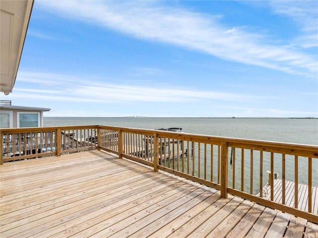 wooden terrace featuring a water view