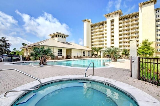 612 Lost Key Dr Unit 205B, Pensacola, FL 32507 - community pool with a community hot tub, fence, and a patio area