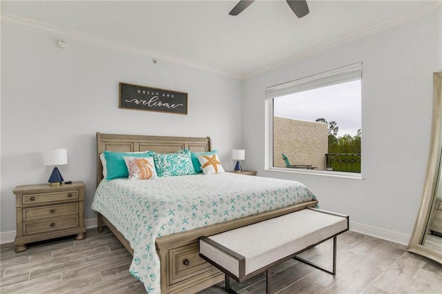 bedroom featuring crown molding, hardwood / wood-style flooring, and ceiling fan