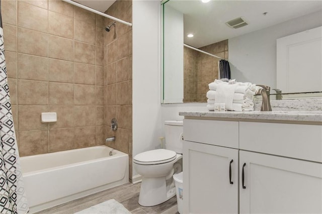 full bathroom with vanity, toilet, wood-type flooring, and shower / bath combination with curtain