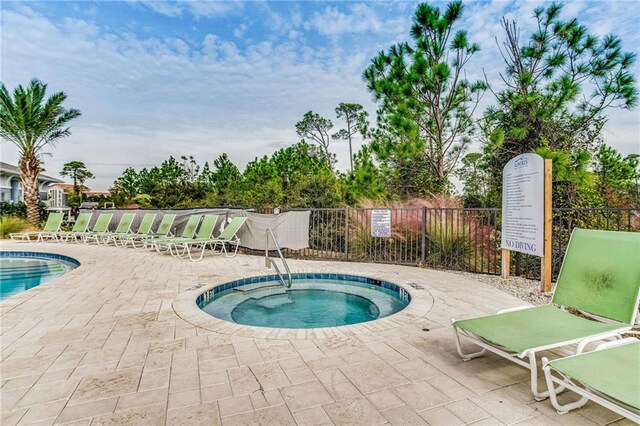 view of pool featuring a patio area and a community hot tub