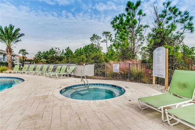 view of swimming pool with a patio area and a community hot tub