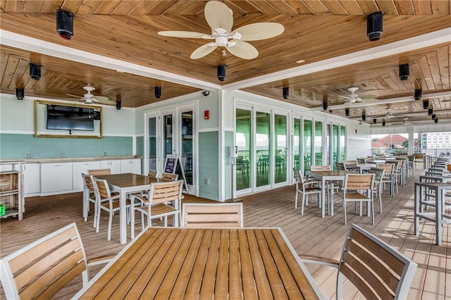 exterior space featuring beam ceiling, wood ceiling, and ceiling fan