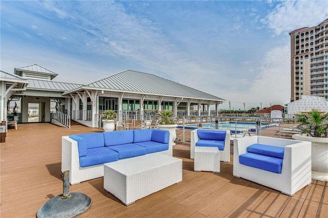 wooden deck featuring a community pool and an outdoor living space