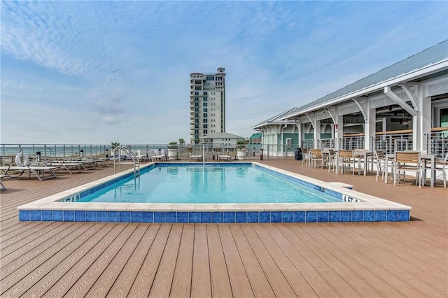 view of swimming pool featuring a water view