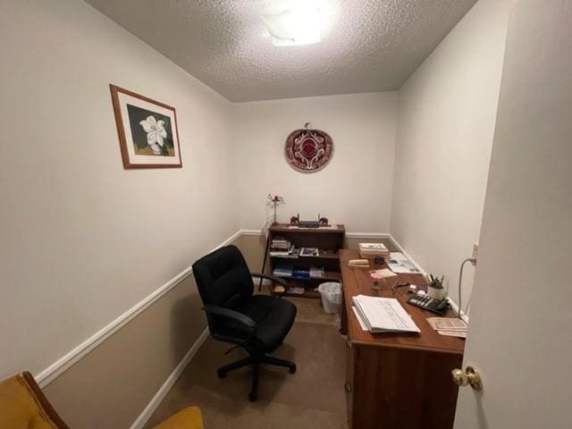 home office with carpet flooring and a textured ceiling