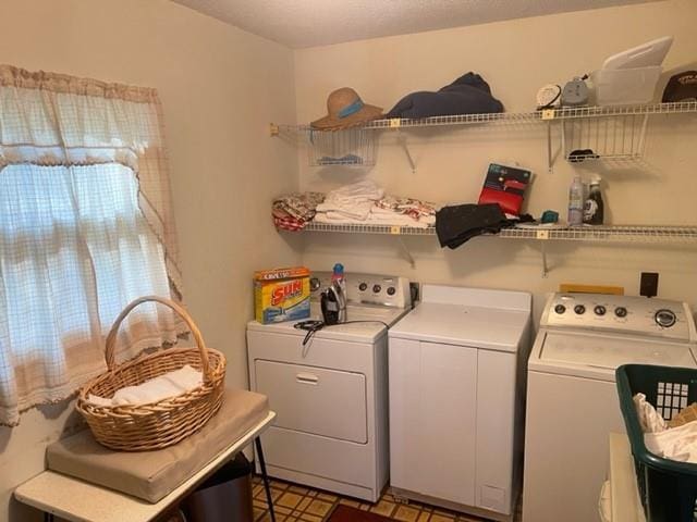 clothes washing area with independent washer and dryer