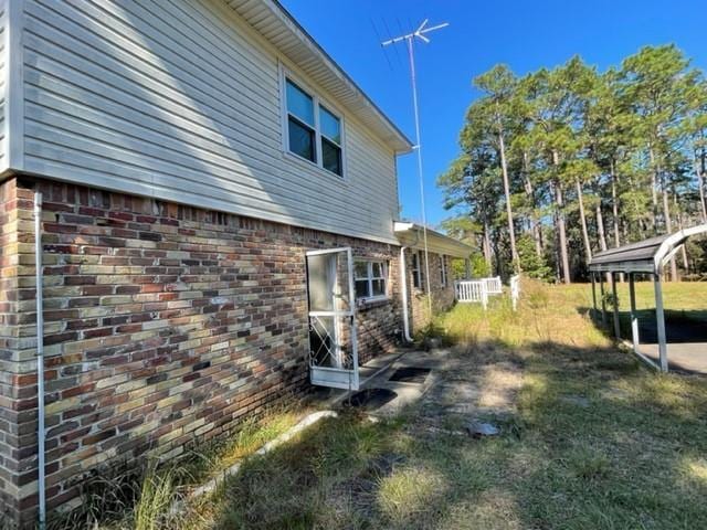 view of side of home with a lawn