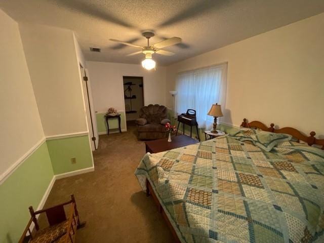 carpeted bedroom with a textured ceiling and ceiling fan