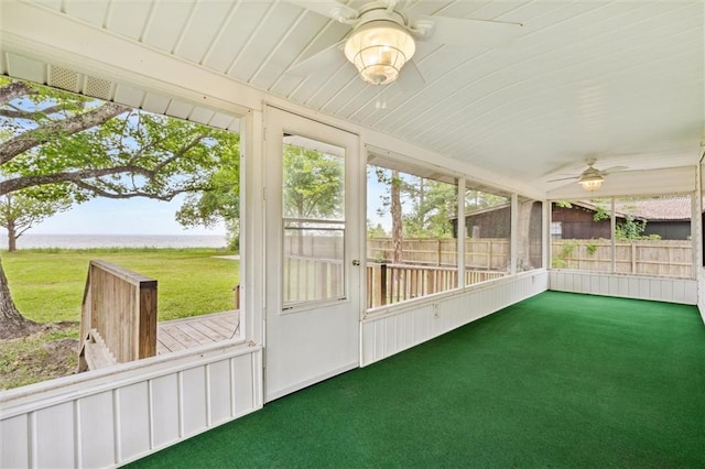 unfurnished sunroom featuring ceiling fan