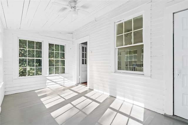 unfurnished sunroom featuring ceiling fan, wooden ceiling, and lofted ceiling