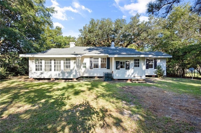 back of property with a lawn and central AC unit