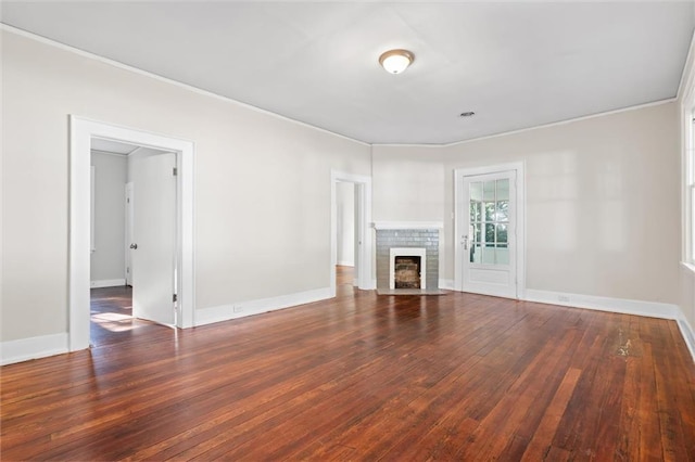 unfurnished living room with crown molding, dark wood-type flooring, and a brick fireplace