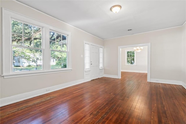 interior space featuring ornamental molding, a chandelier, and dark hardwood / wood-style flooring