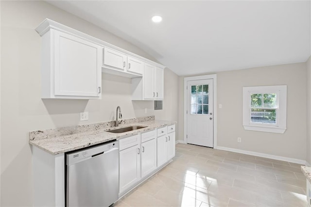 kitchen featuring light stone countertops, sink, lofted ceiling, stainless steel dishwasher, and white cabinets