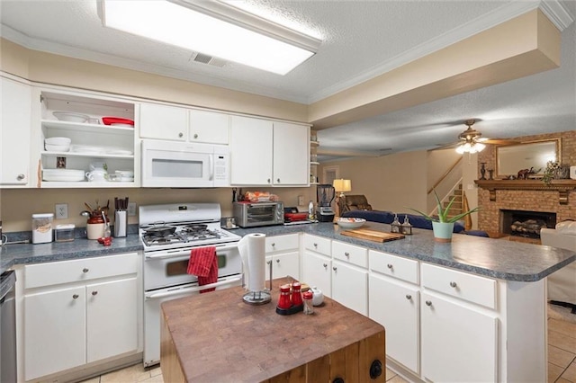 3765 Rabbit Creek Ct, Theodore, AL 36582 - kitchen featuring white appliances, a peninsula, dark countertops, open floor plan, and a fireplace