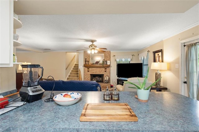 3765 Rabbit Creek Ct, Theodore, AL 36582 - living room with a fireplace, ceiling fan, stairs, ornamental molding, and a textured ceiling