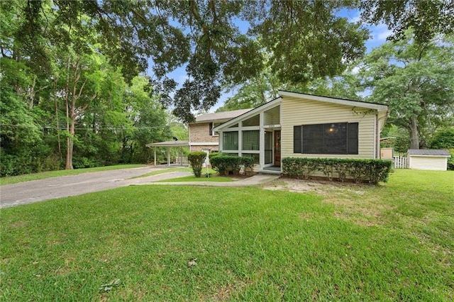 3765 Rabbit Creek Ct, Theodore, AL 36582 - mid-century modern home featuring asphalt driveway, a carport, and a front lawn