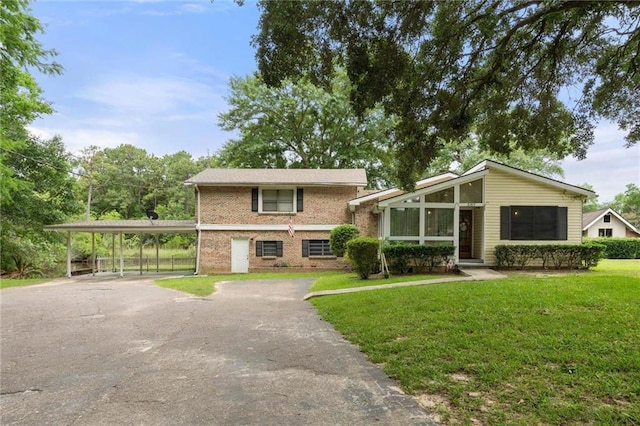3765 Rabbit Creek Ct, Theodore, AL 36582 - view of front of home featuring asphalt driveway, a front lawn, a carport, and brick siding
