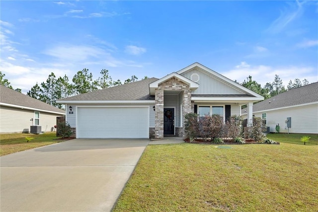 view of front of home featuring central AC, a front yard, and a garage