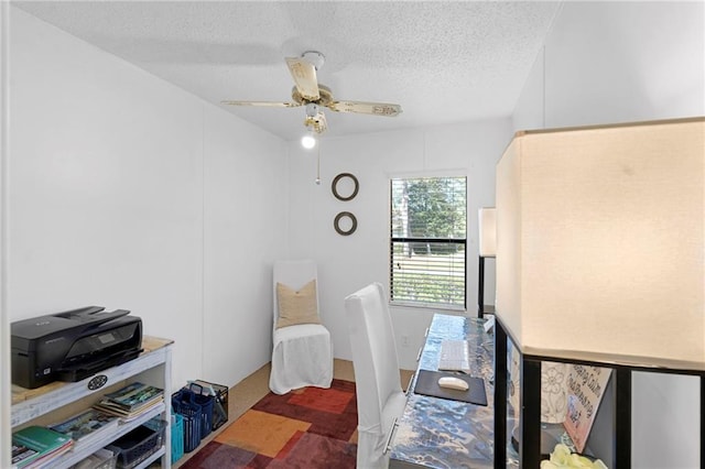 home office featuring a textured ceiling and ceiling fan