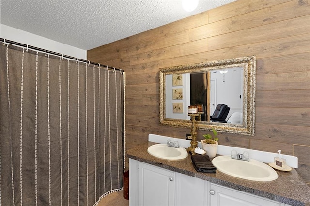 bathroom featuring vanity, a textured ceiling, wooden walls, and a shower with shower curtain