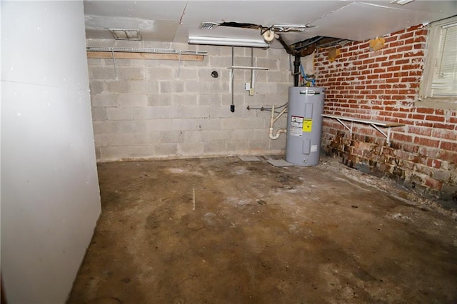 basement featuring concrete block wall and water heater