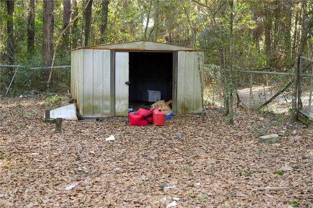 view of shed with fence