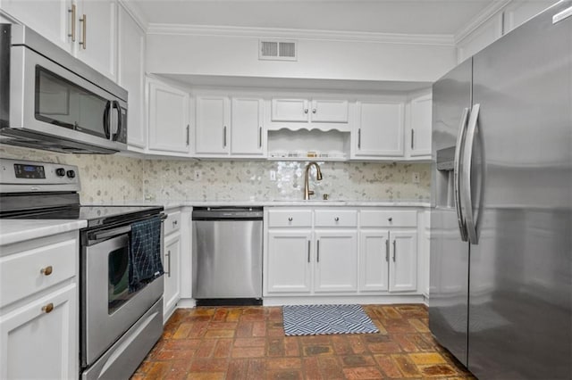 kitchen with ornamental molding, stainless steel appliances, white cabinets, and sink