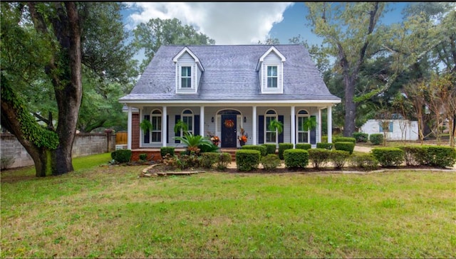 cape cod house featuring a front lawn