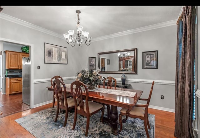 dining area with an inviting chandelier, wood-type flooring, and crown molding