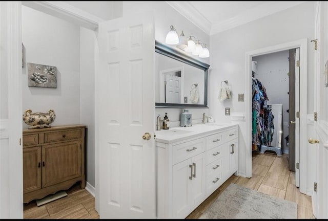 bathroom with vanity, wood-type flooring, and ornamental molding