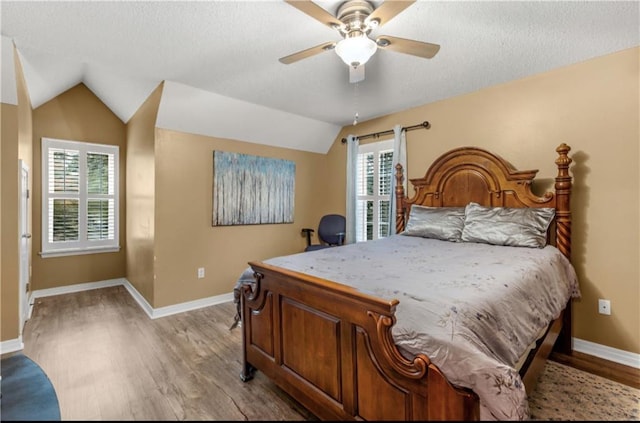 bedroom with light hardwood / wood-style floors, ceiling fan, and lofted ceiling