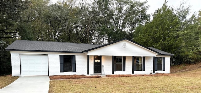 ranch-style home with a garage and a front lawn