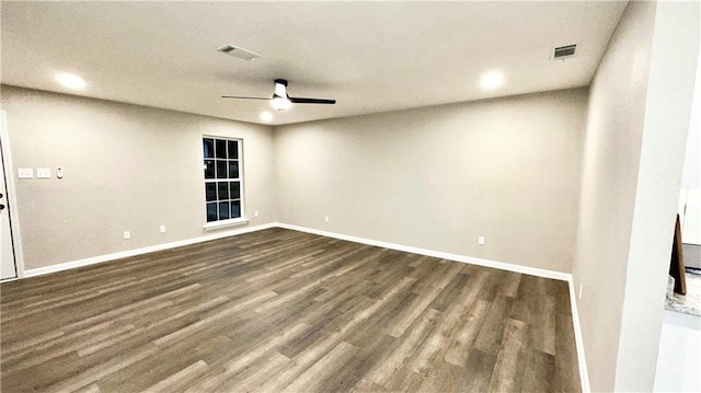 spare room with dark wood-type flooring and ceiling fan