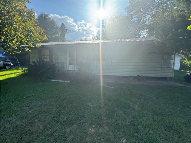 view of side of property with a yard