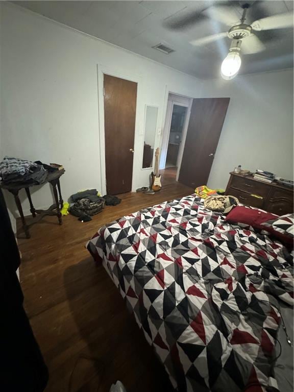 bedroom with ceiling fan and wood-type flooring