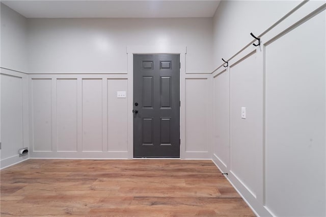 entryway with a decorative wall and light wood-style floors