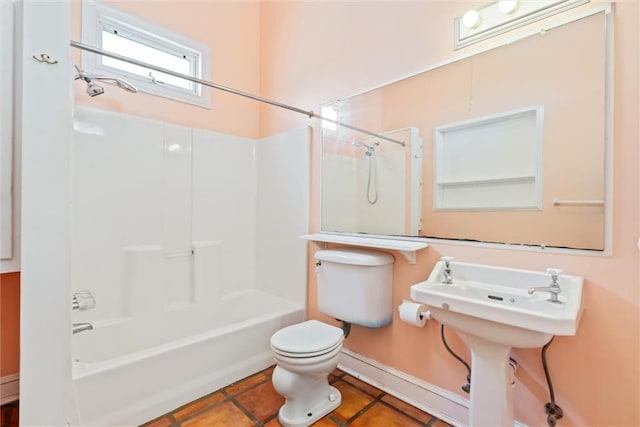 bathroom featuring washtub / shower combination, tile floors, and toilet