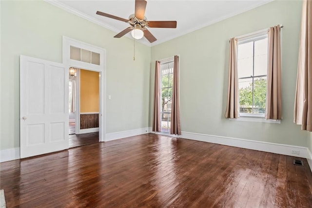 empty room featuring ornamental molding, plenty of natural light, dark wood-type flooring, and ceiling fan