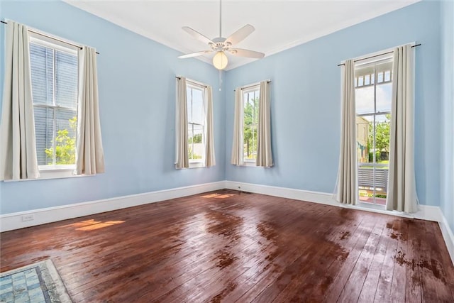 unfurnished room with hardwood / wood-style floors, ceiling fan, and a wealth of natural light