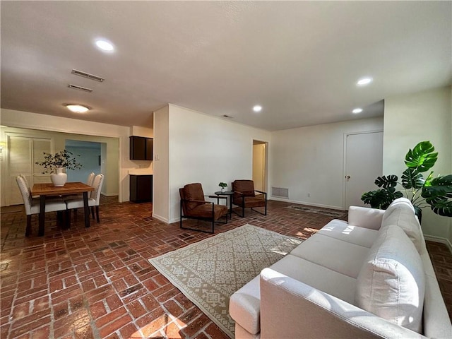 332 Syracuse St, Mobile, AL 36608 - living room featuring brick floors, recessed lighting, and baseboards