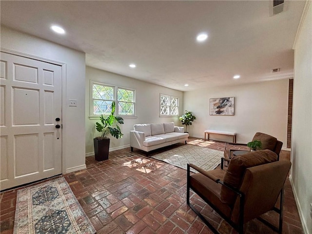 332 Syracuse St, Mobile, AL 36608 - living room featuring baseboards, recessed lighting, and brick flooring