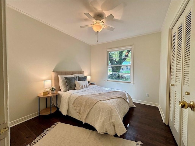 332 Syracuse St, Mobile, AL 36608 - bedroom with baseboards, wood finished floors, crown molding, a closet, and a ceiling fan