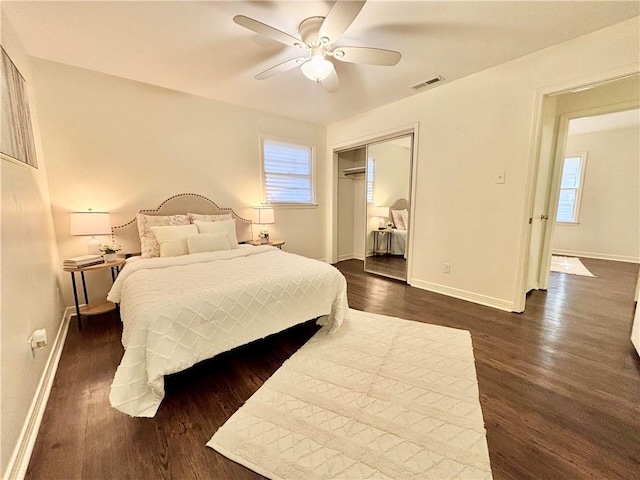 332 Syracuse St, Mobile, AL 36608 - bedroom featuring dark wood-style flooring, baseboards, multiple windows, and a closet