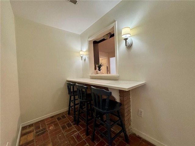 332 Syracuse St, Mobile, AL 36608 - bar area with baseboards and brick patterned flooring