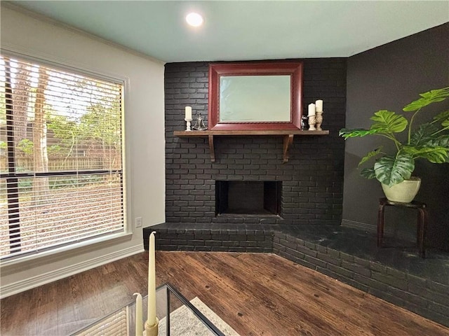 332 Syracuse St, Mobile, AL 36608 - living room with wood finished floors, baseboards, and a fireplace