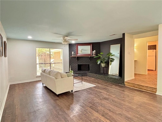 332 Syracuse St, Mobile, AL 36608 - living room with a ceiling fan, a fireplace, baseboards, and wood finished floors