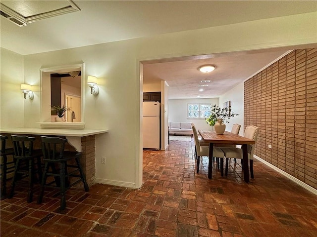 332 Syracuse St, Mobile, AL 36608 - dining room with baseboards and brick flooring